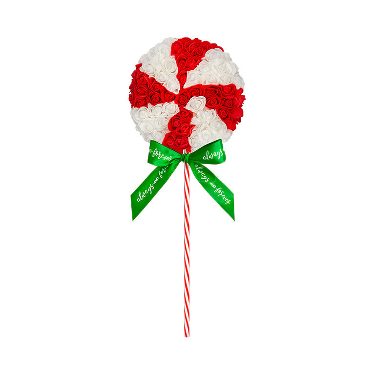 Floral arrangement designed as a peppermint candy with red and white flowers on a candy cane stick, finished with a green ribbon displaying "Always and forever", ideal as a holiday gift or decoration.