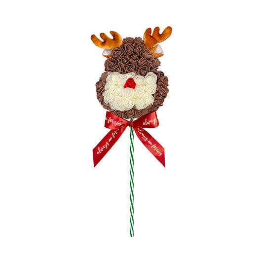 A bouquet designed to resemble a reindeer, with brown and cream roses, antler accents, and a red bow with affectionate messages.