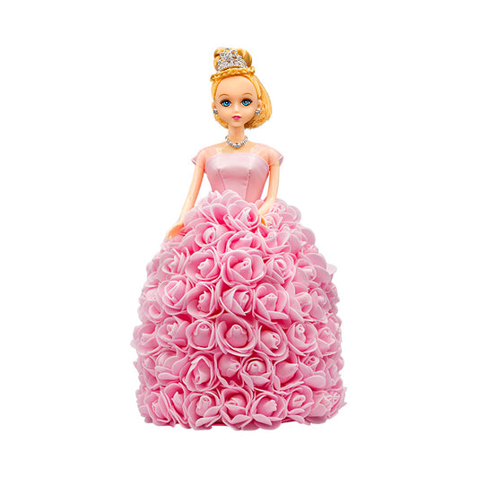 A decorative doll with a handcrafted skirt of pink flowers, a silver tiara and jewelry, evoking a regal look. Ideal for anniversaries, birthdays, graduations, Christmas, Valentine's Day, Quinceañeras, or as a unique collectible gift.