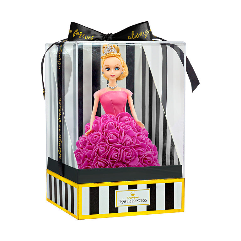  The doll is presented in packaging, which includes a clear plastic cover and a box with black and white stripes, accented with gold trim. The words "Flower Princess" are displayed on the front label. A black ribbon with the text "forever always" is tied in a bow at the top.
