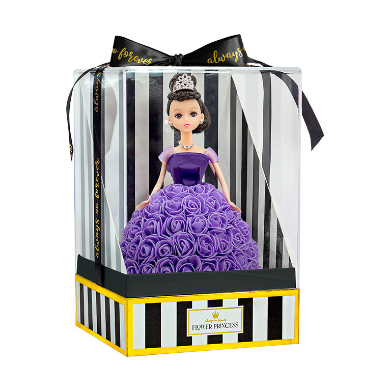 The doll is shown inside packaging, which features a see-through plastic cover and a box with black and white stripes, outlined with gold trim. The inscription "Flower Princess" appears on the front label. A black ribbon with the phrase "forever always" is tied in a bow at the top.