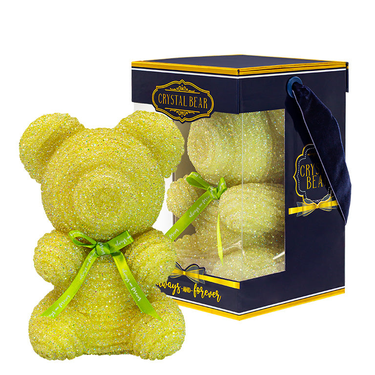This is a lime green crystal bear with a green ribbon around its neck that says "Always and Forever." It sits within a clear plastic box with a navy blue and gold-trimmed base, labeled "CRYSTAL BEAR."