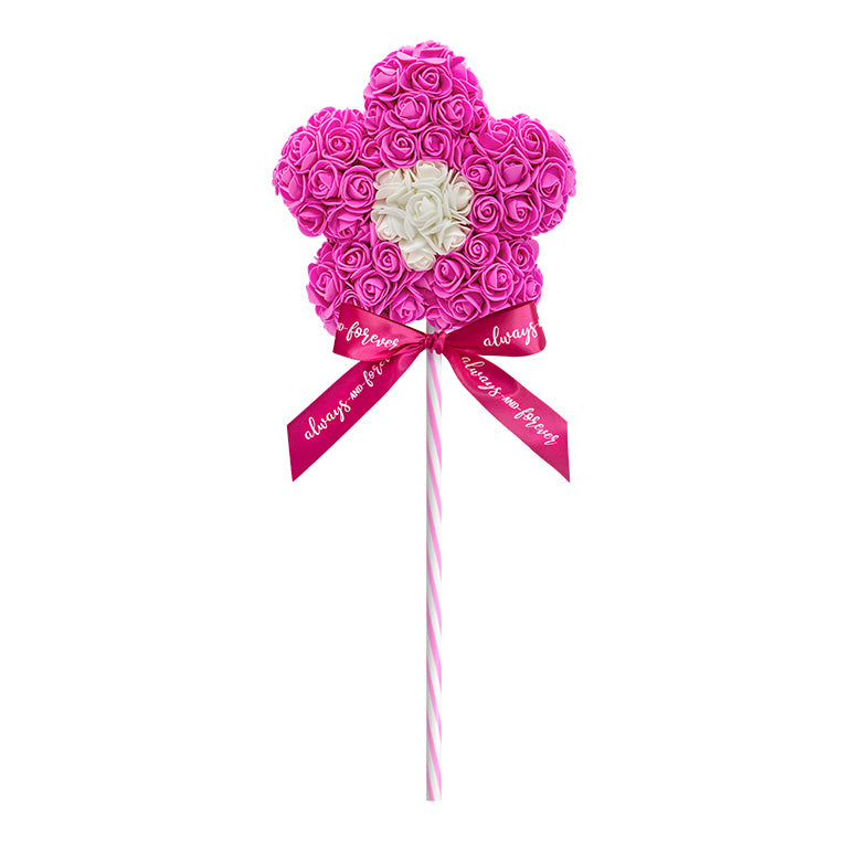 A decorative flower-shaped lollipop, crafted with a bright pink floral arrangement standing on a bright pink striped stick, and adorned with a bright pink ribbon reading "Always and Forever." This piece is perfect for anniversaries, birthdays, graduations, Christmas, Valentine's Day, gender reveal and more. A unique and charming gift idea that can be treasured year-round.