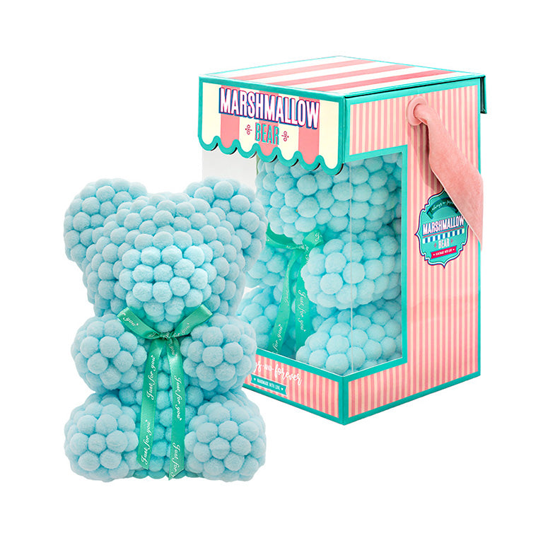Bear made out of light pink-colored faux marshmallows. The bear is adorned with a green ribbon tied into a bow around its neck, and it is packaged in a clear-front gift box with a pink and white striped design. The top of the box features a teal and pink label that reads "MARSHMALLOW BEAR." This delightful creation is an excellent gift idea for various occasions such as anniversaries, birthdays, graduations, Christmas, Valentine's Day, or simply as a unique gift for someone special.	