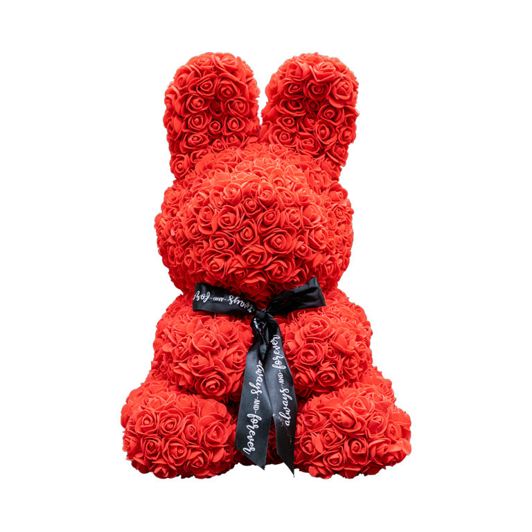 Front view of a red flower bunny made of foam roses with upright ears and a black ribbon that reads "Always and Forever."
