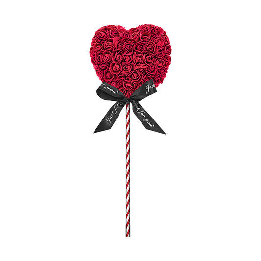 A product designed like a lollipop with the shape of a heart covered in burgundy foam roses