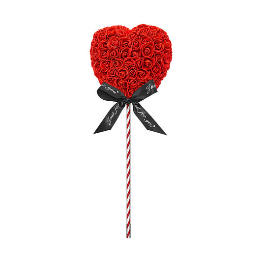 A product designed like a lollipop with the shape of a heart covered in red foam roses