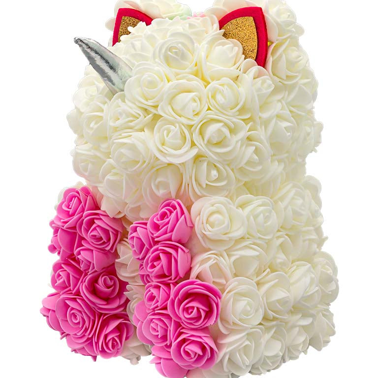 A back view of a unicorn shaped product covered in foam roses in the color white and pink. And a patch of various colors that would be the hair/mane