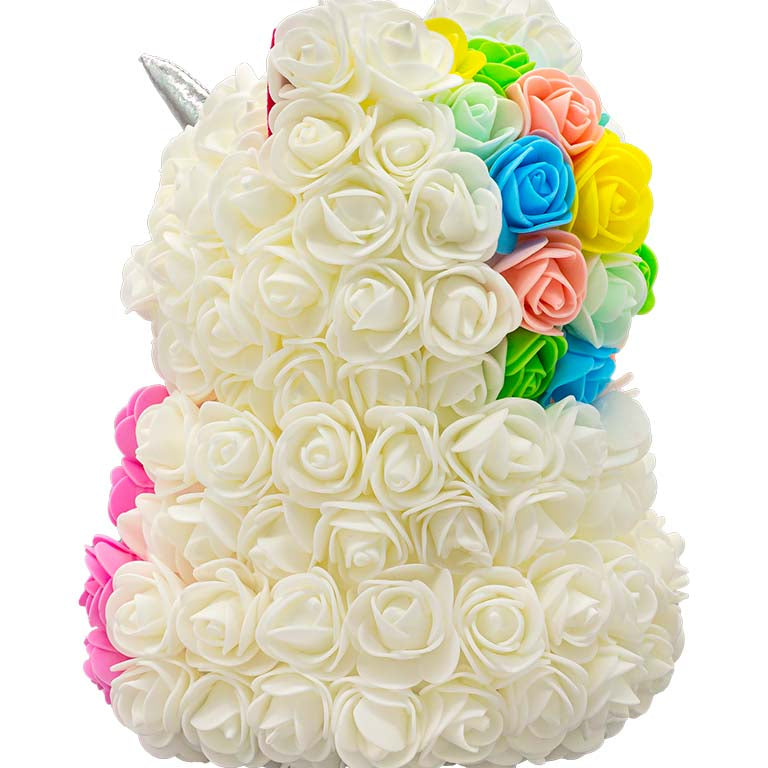 A side view of a unicorn shaped product covered in foam roses in the color white and pink.