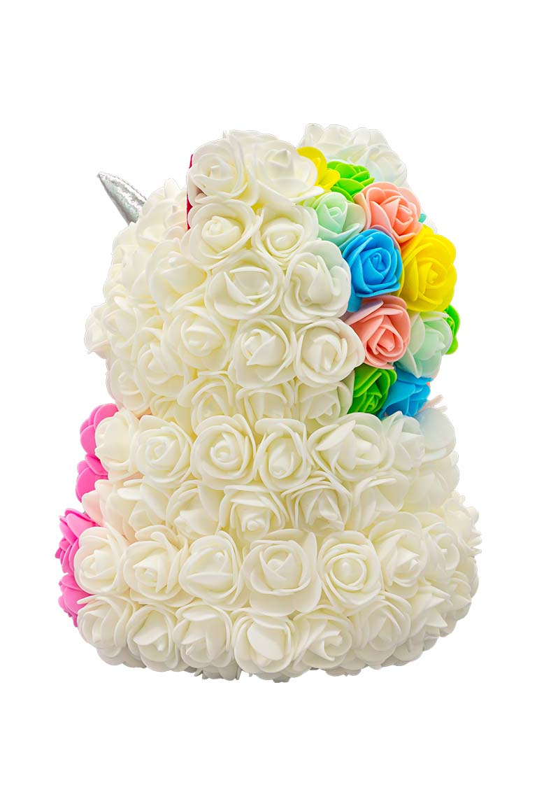 A side view of a unicorn shaped product covered in foam roses in the color white and pink.