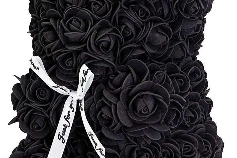 A bear shaped product covered in foam roses in the color black.