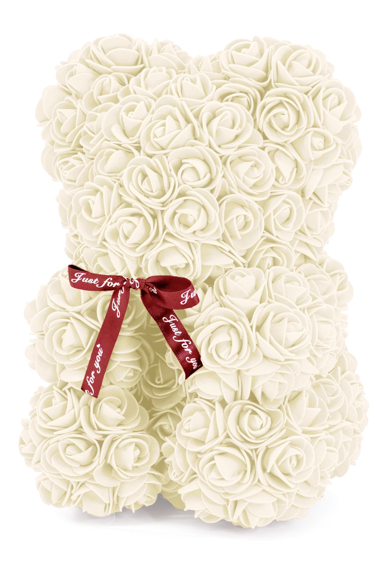 A front view of the bear shaped product covered in foam roses in the color of cream.