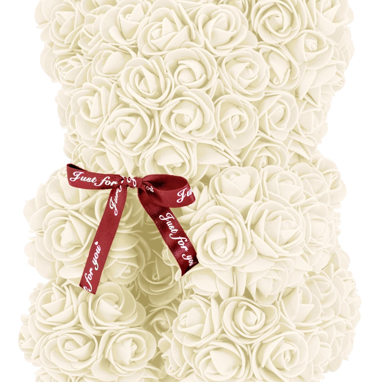 A bear shaped product covered in foam roses in the color cream.