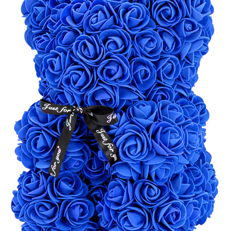 A bear shaped product covered in foam roses in the color navy.