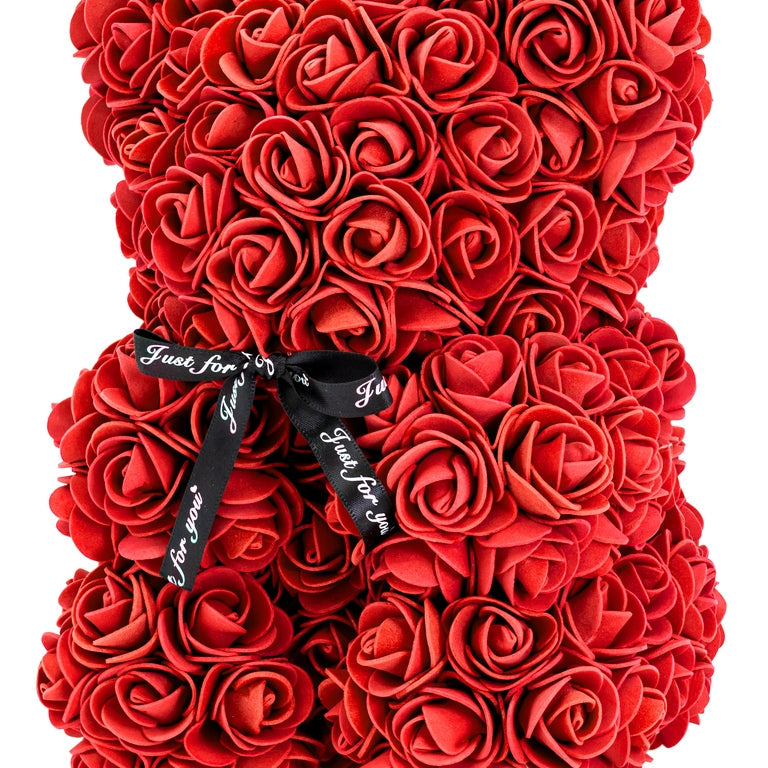 A bear shaped product covered in foam roses in the color red.