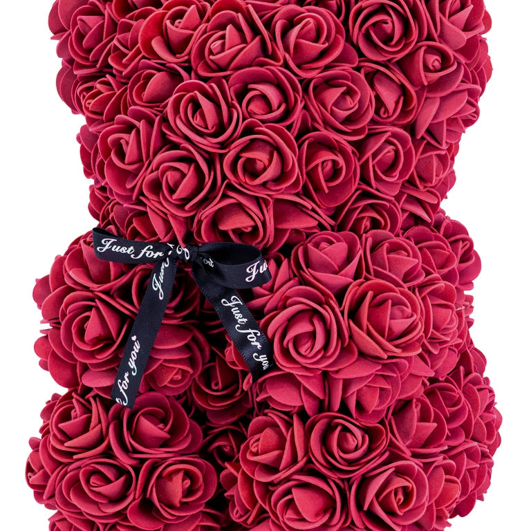 A front view of the bear shaped product covered in foam roses in the color of burgundy.