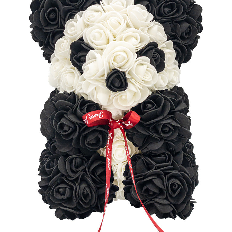 A front view if a panda shaped product covered in foam roses in the color black and white.