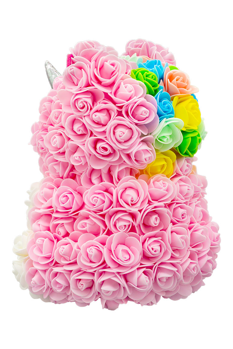 A back view of a unicorn shaped product covered in foam roses in the color pink and white. And a patch of various colors that would be the hair/mane