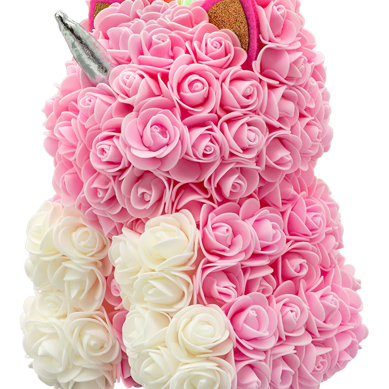 A side view of a unicorn shaped product covered in foam roses in the color pink and white.