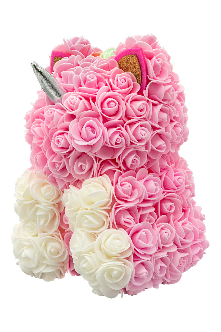 A side view of a unicorn shaped product covered in foam roses in the color pink and white.