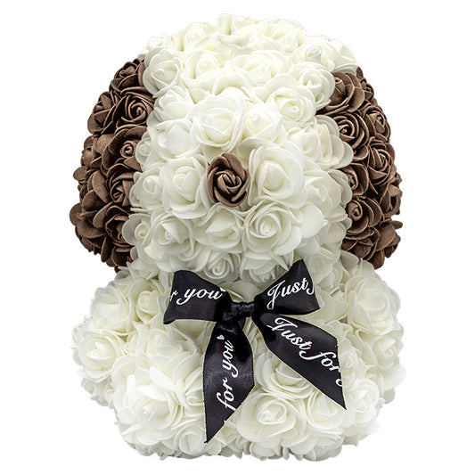 A front view of a puppy shaped product covered in foam roses. The main body is white. The ears and nose are colored brown