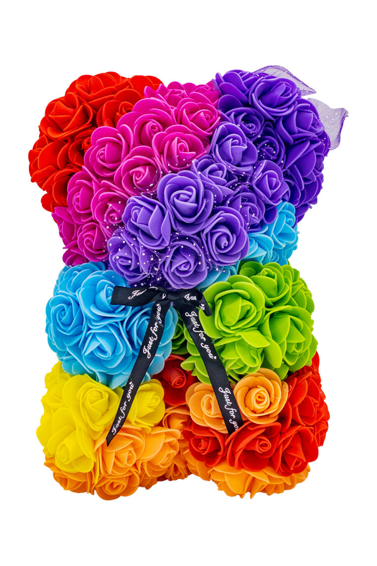 A front view of the bear shaped product covered in foam roses in the color of the rainbow.
