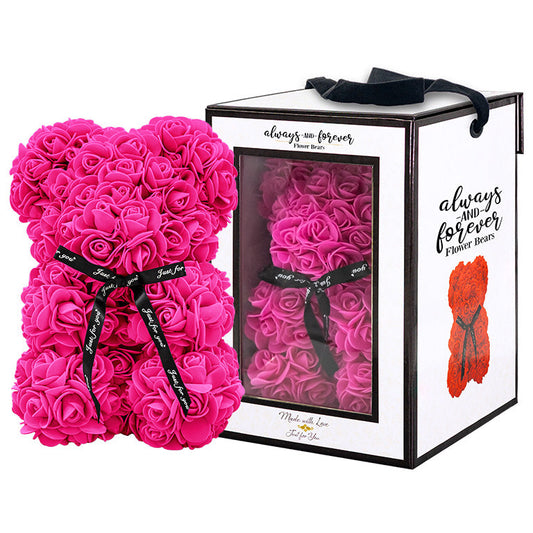 A bear shaped product covered in foam roses in the color of rose. Behind the item is the packaging box of the product.